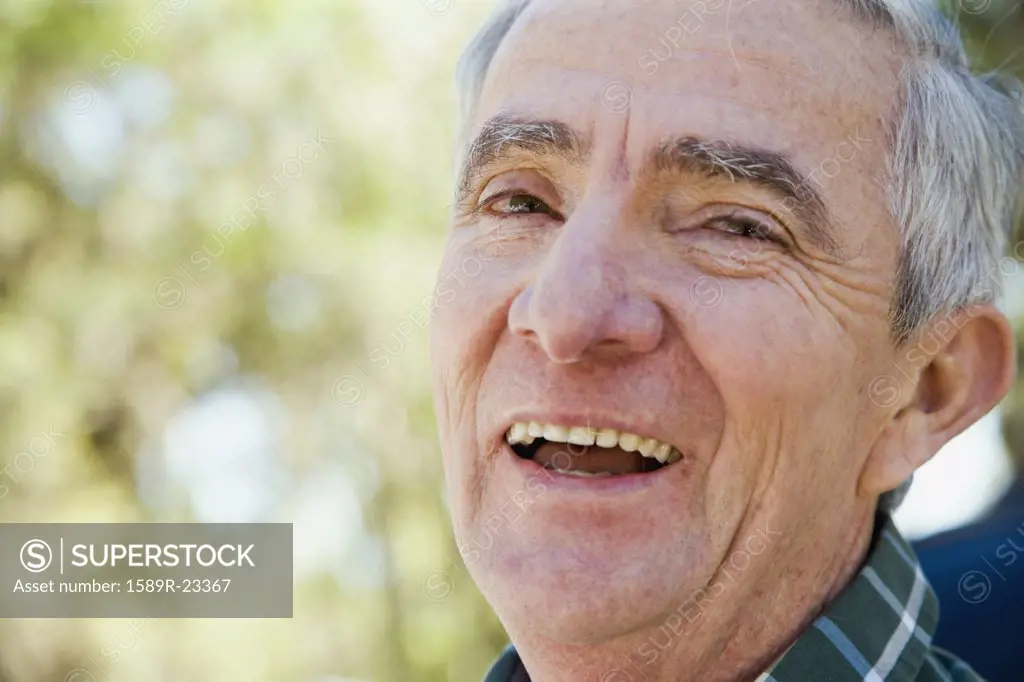 Close up of senior Hispanic man laughing