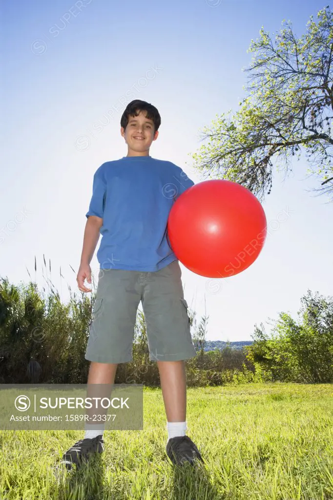 Boy with ball in bright sunlight
