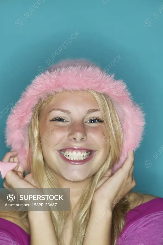 Close up of girl wearing pink hat and smiling