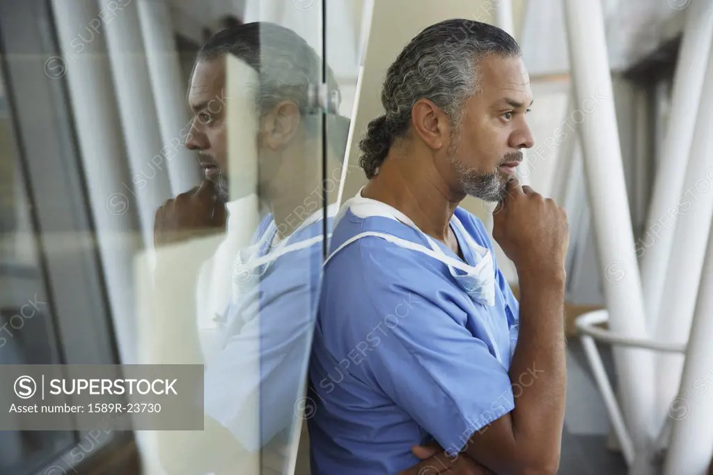 Middle-aged male African surgeon thinking