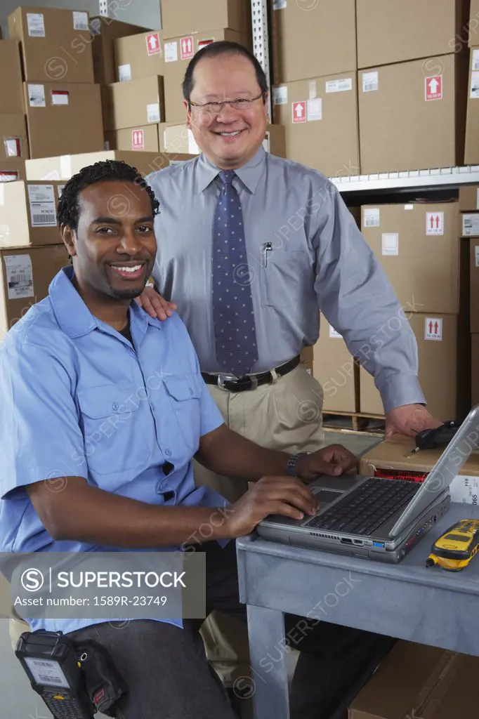 Businessman and co-worker in shipping department