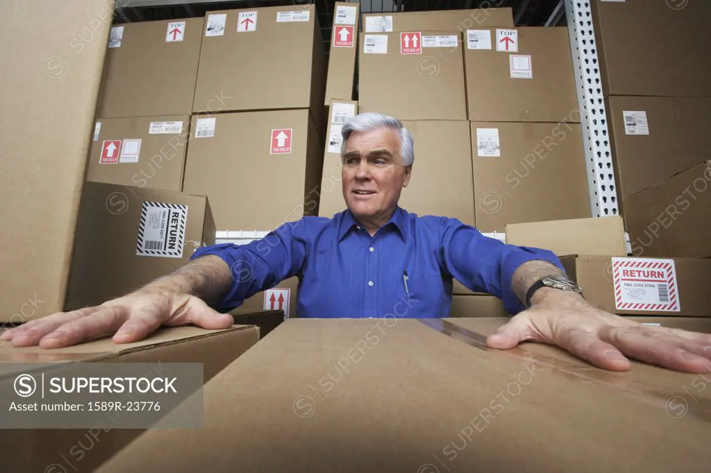 Frustrated businessman in warehouse