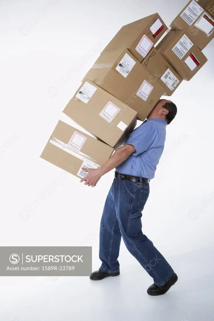 Studio shot of male warehouse worker carrying packages