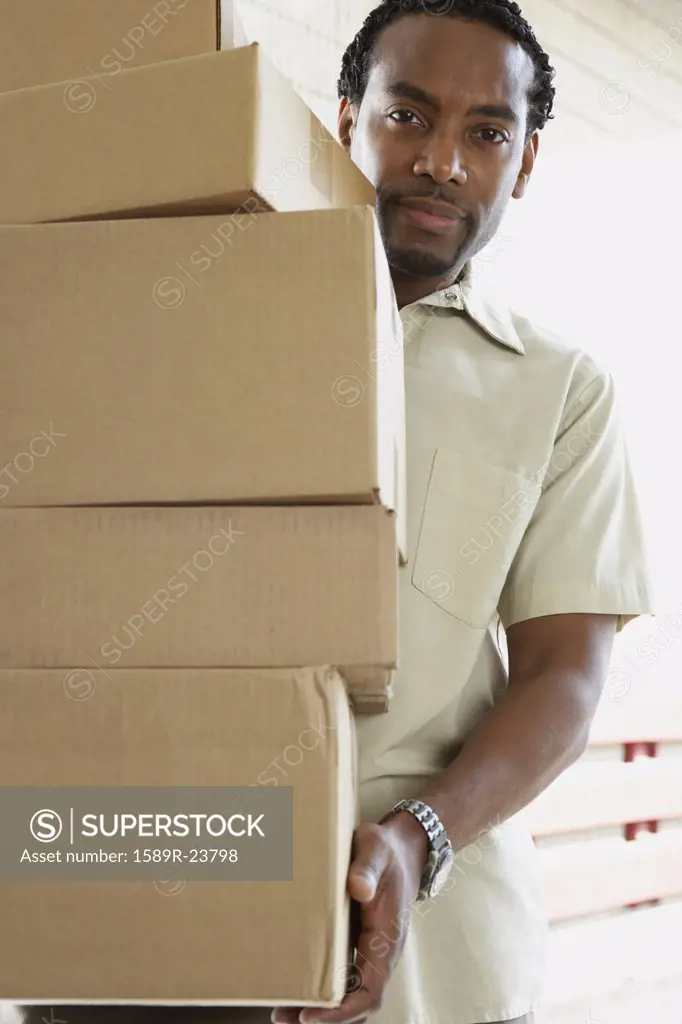 African man carrying boxes