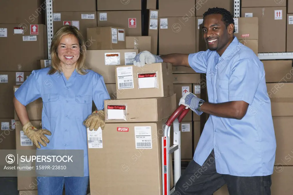Male and female warehouse workers in warehouse