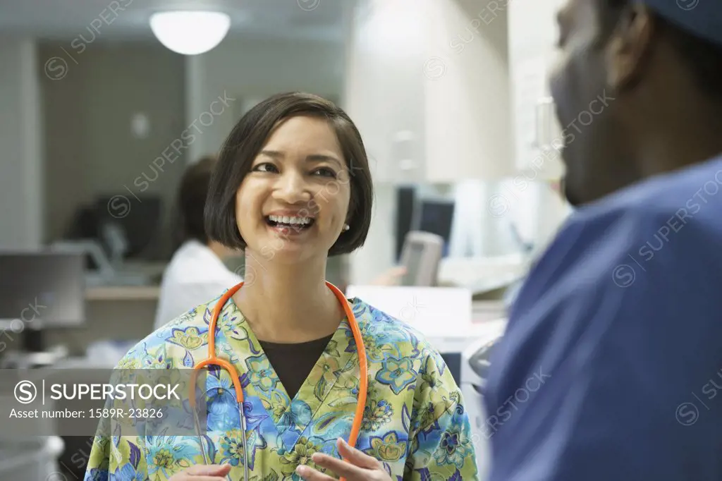 Female nurse talking to co-worker, Bethesda, Maryland, United States