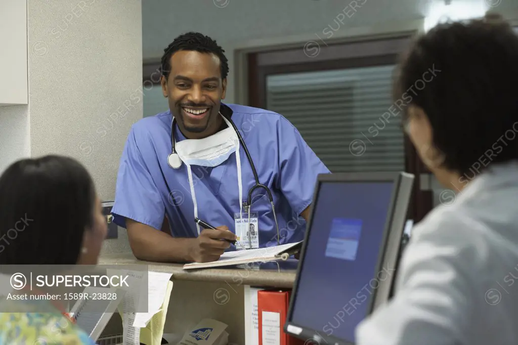 African male surgeon talking to co-workers, Bethesda, Maryland, United States