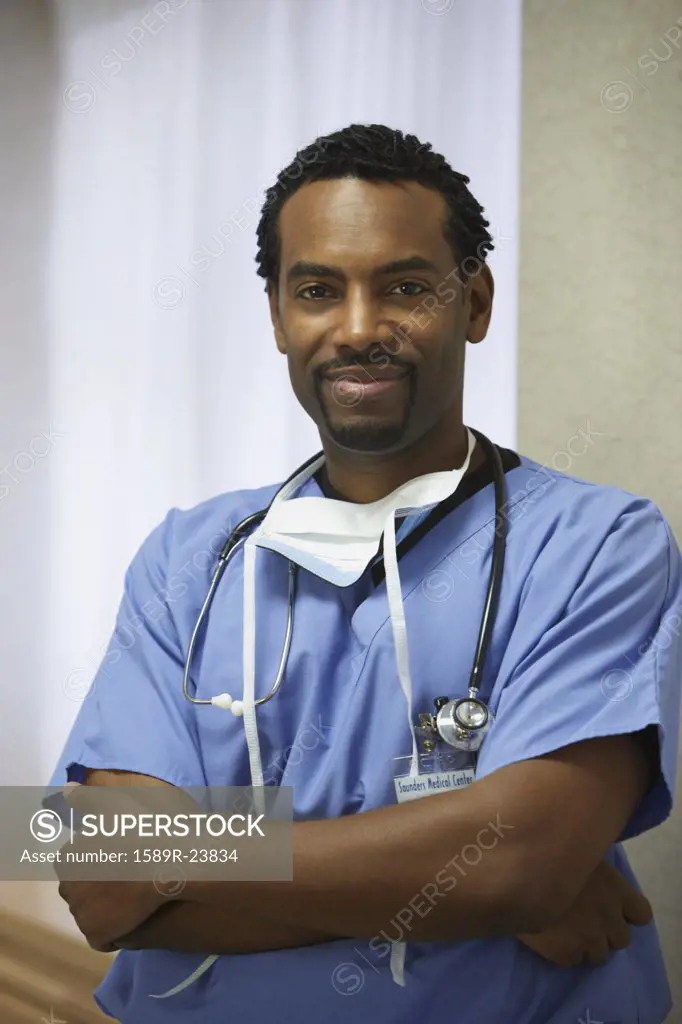 African male surgeon with arms crossed