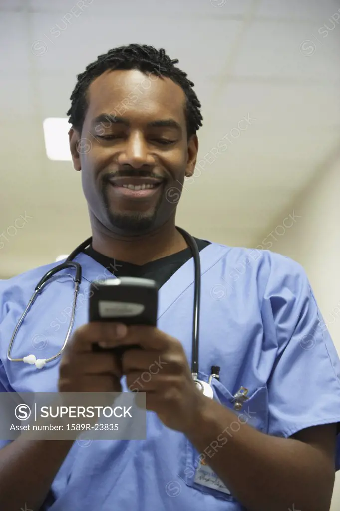 African male surgeon using electronic organizer