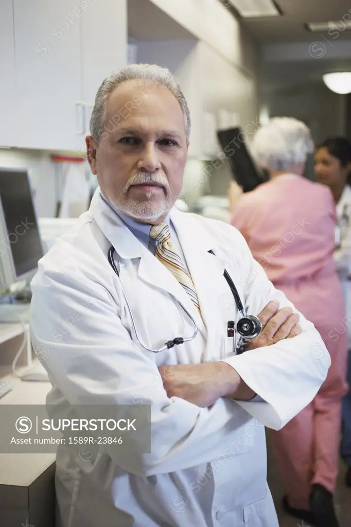 Middle-aged male doctor with arms crossed, Bethesda, Maryland, United States