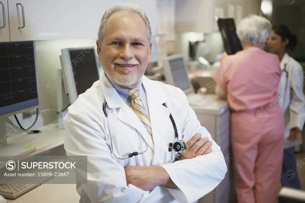 Middle-aged male doctor smiling, Bethesda, Maryland, United States