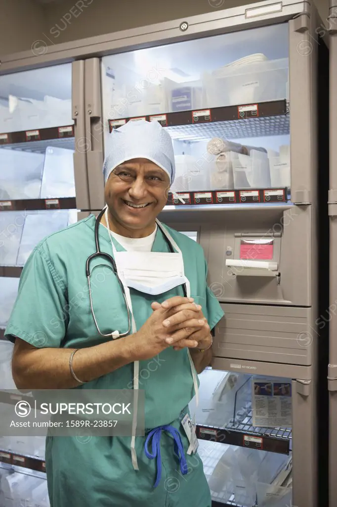 Middle-aged Indian male surgeon in supply room, Bethesda, Maryland, United States