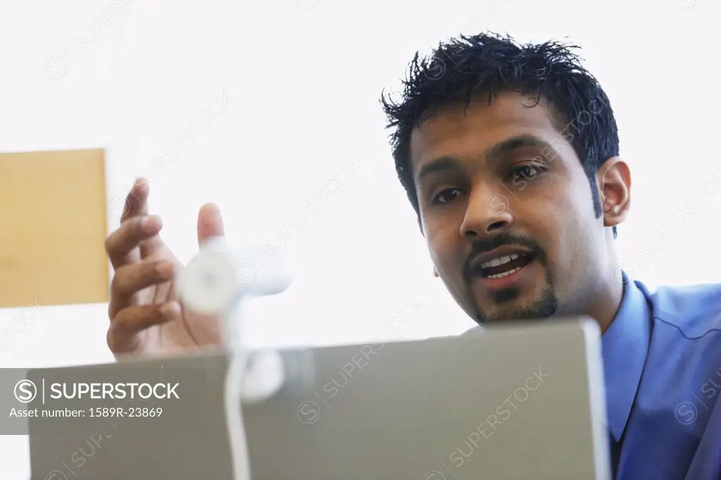 Indian businessman using webcam