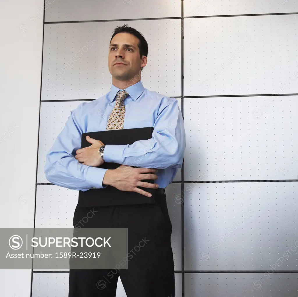 Businessman standing in front of wall
