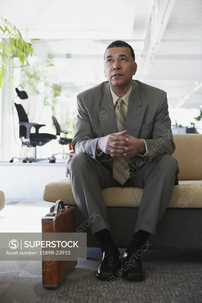 African American businessman sitting in waiting area