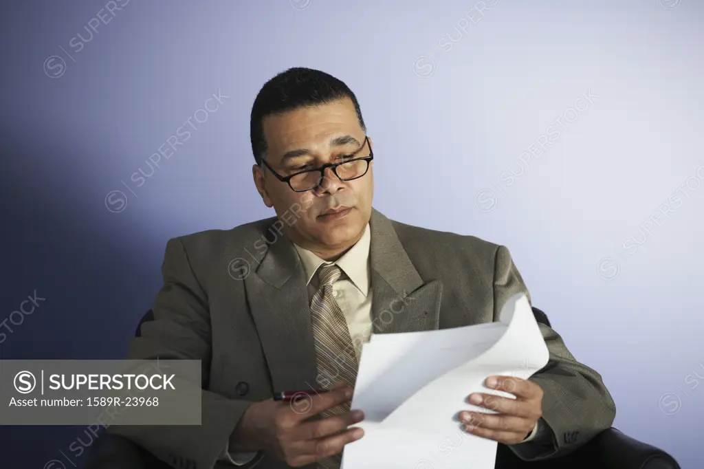 African American businessman reading paperwork