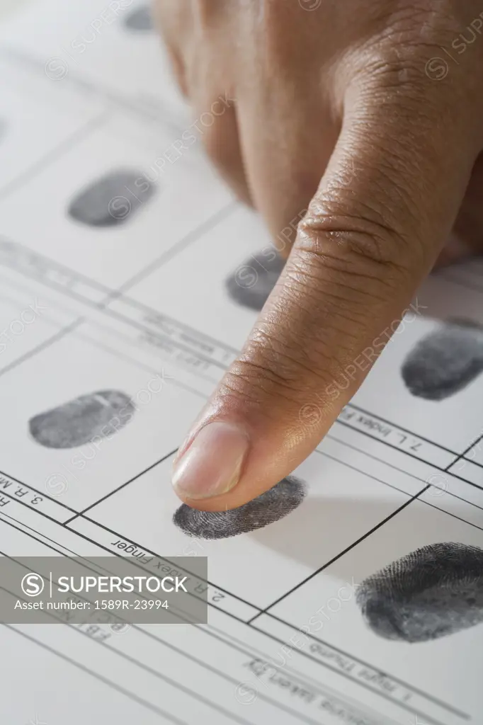 Close up of African male hand and fingerprint card