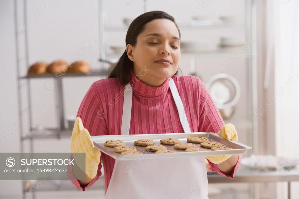 Hispanic woman with tray of cookies