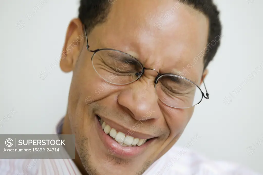 Close up of African American man smiling with eyes closed