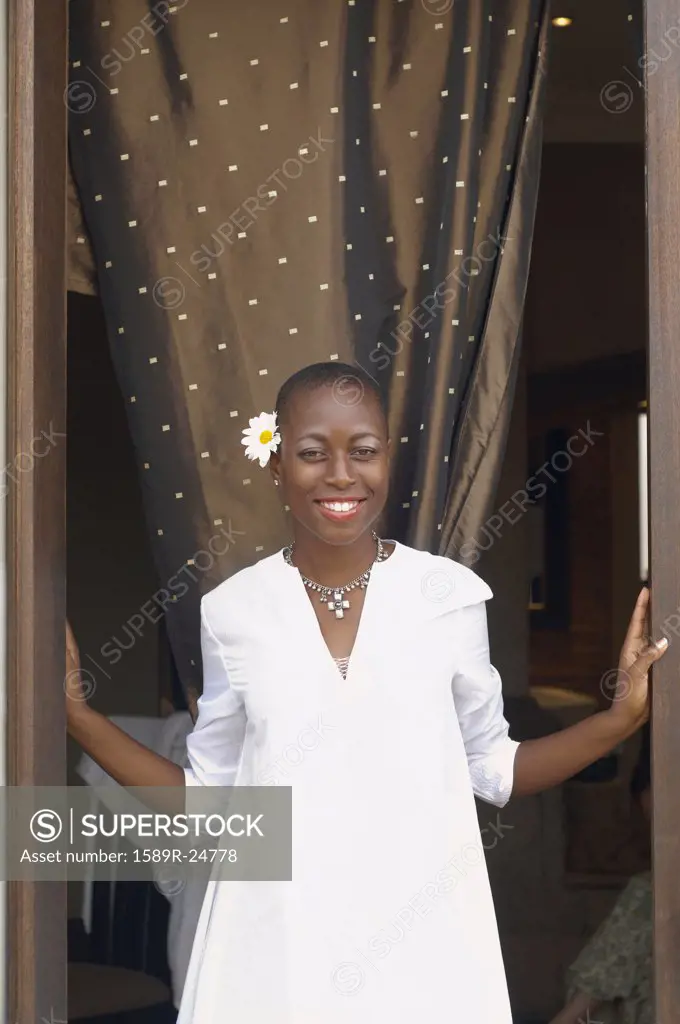 African American woman in doorway smiling