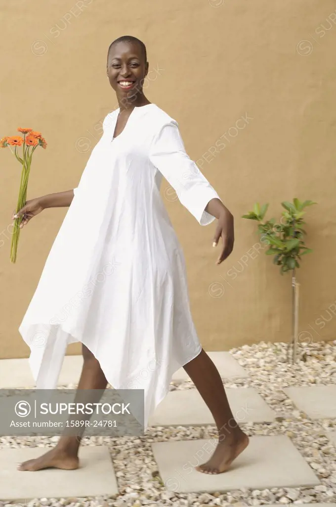 African American woman walking on flagstones