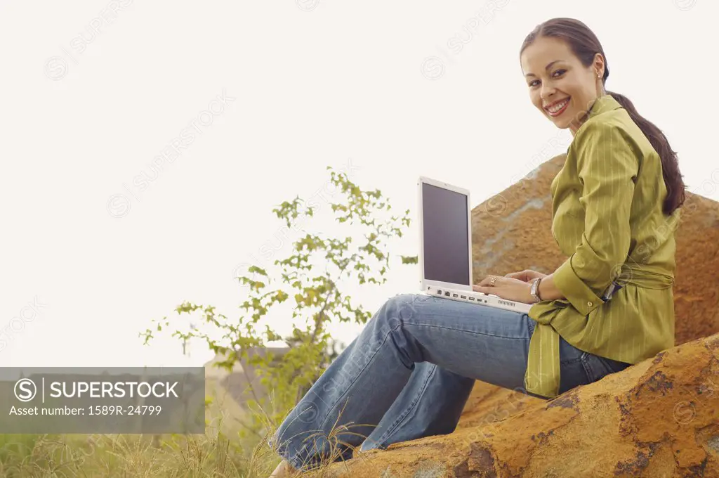 Woman with laptop outdoors