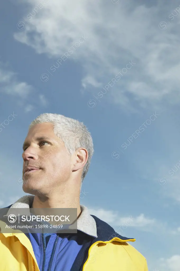 Low angle view of middle-aged man under blue sky, California, United States