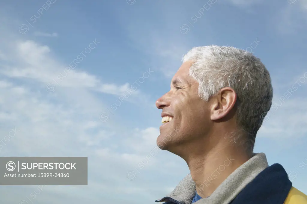 Profile of middle-aged man under blue sky, California, United States
