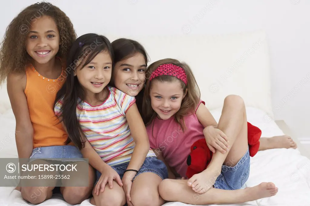 Group of young girls hugging and smiling