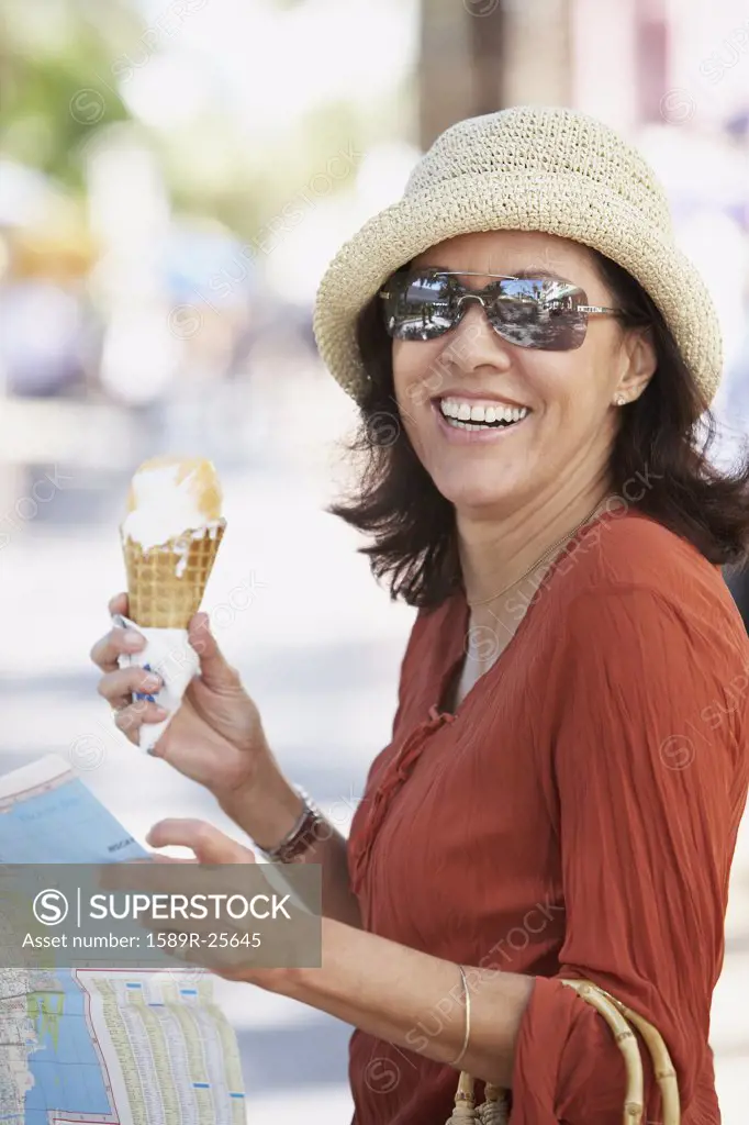 Middle-aged Hispanic woman with ice cream cone, Miami, Florida, United States