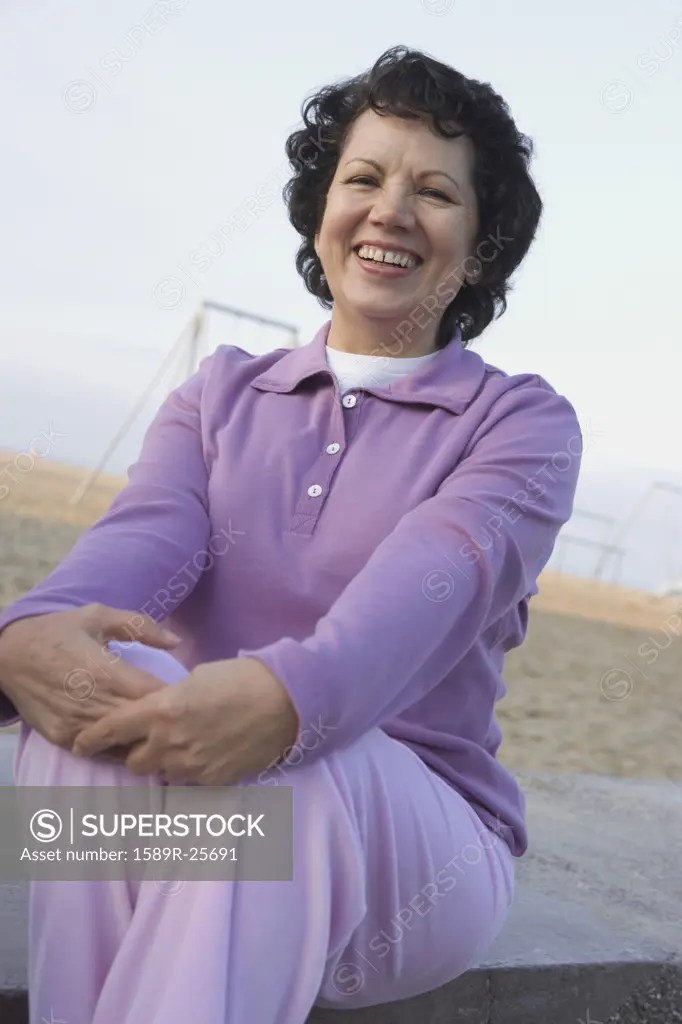 Senior woman sitting at beach