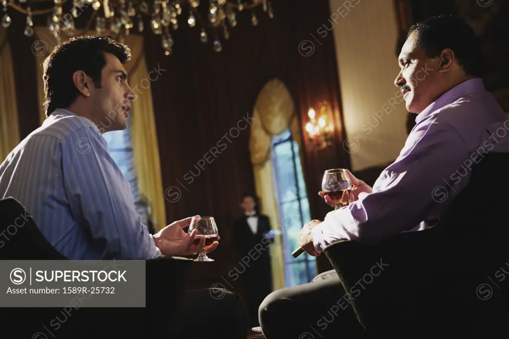 Two men drinking and talking, Sands Point, New York, United States