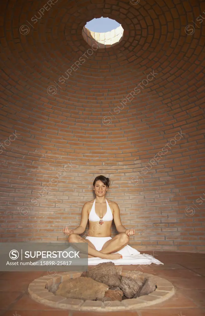 Woman meditating in sweat lodge, Los Cabos, Mexico