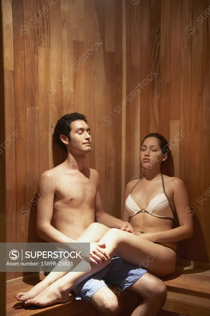 Young Hispanic couple sitting in sauna, Los Cabos, Mexico
