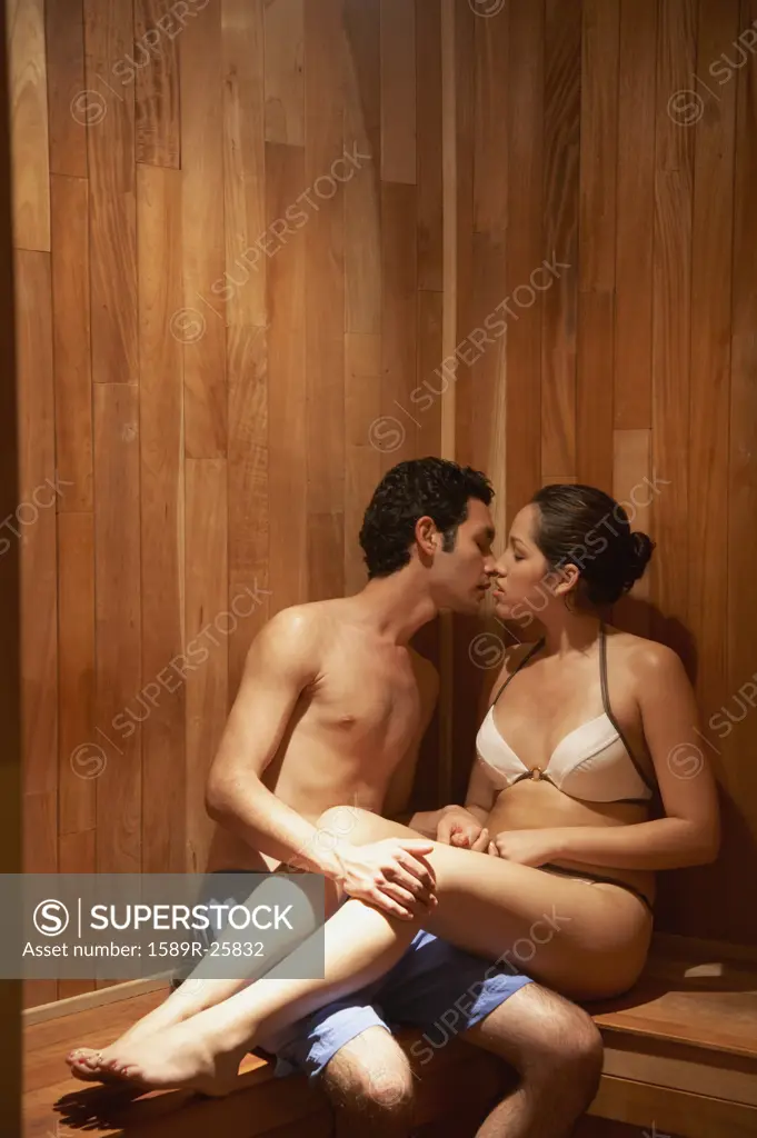 Young Hispanic couple kissing in sauna, Los Cabos, Mexico