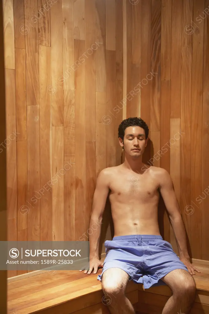 Hispanic man sitting in sauna, Los Cabos, Mexico