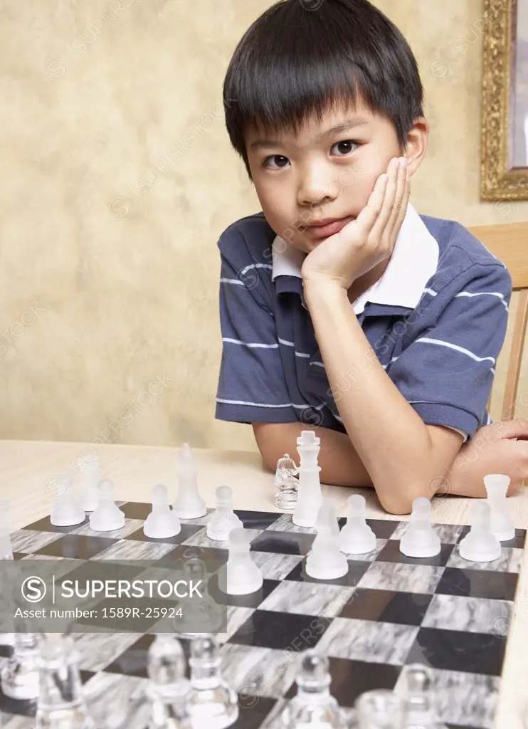 Asian boy playing chess