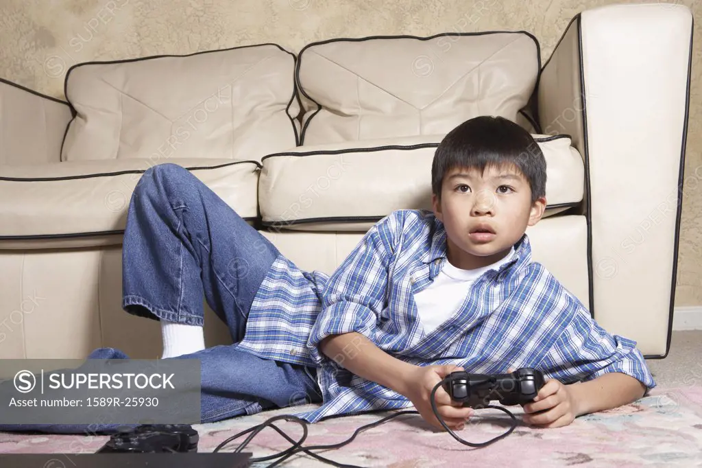 Asian boy playing video games