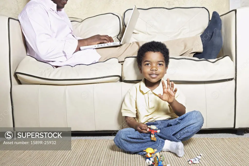 Young African American boy playing on floor