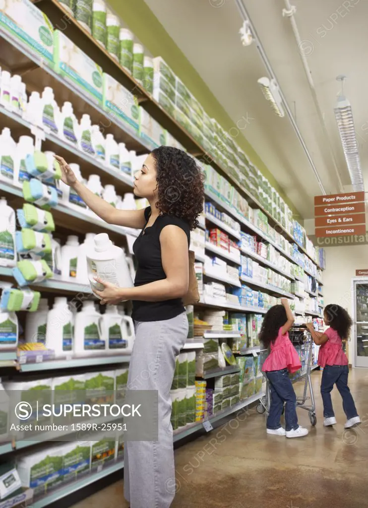 Mother with young daughters in grocery store