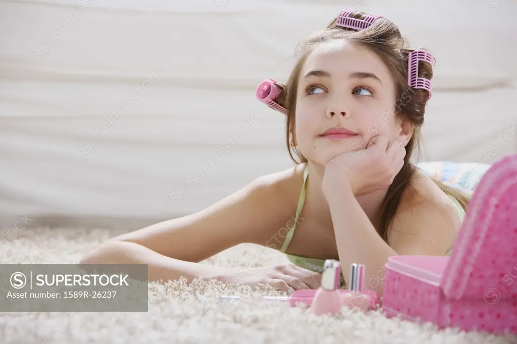 Young girl with makeup and curlers