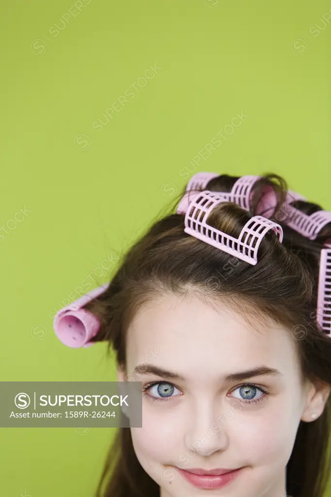 Studio shot of young girl with curlers