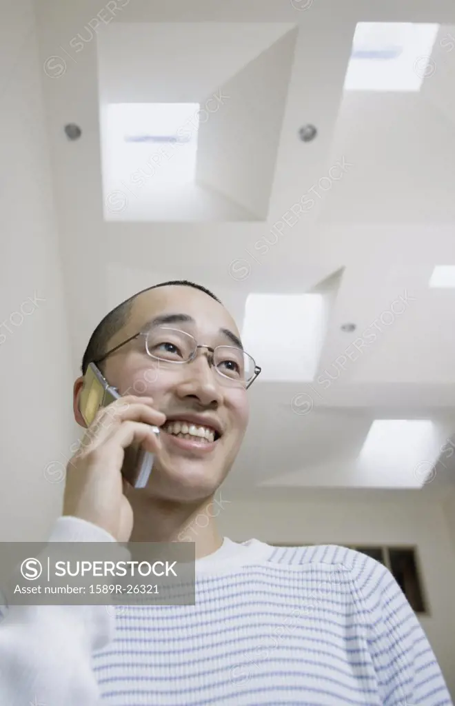 Male Asian teenager on cell phone