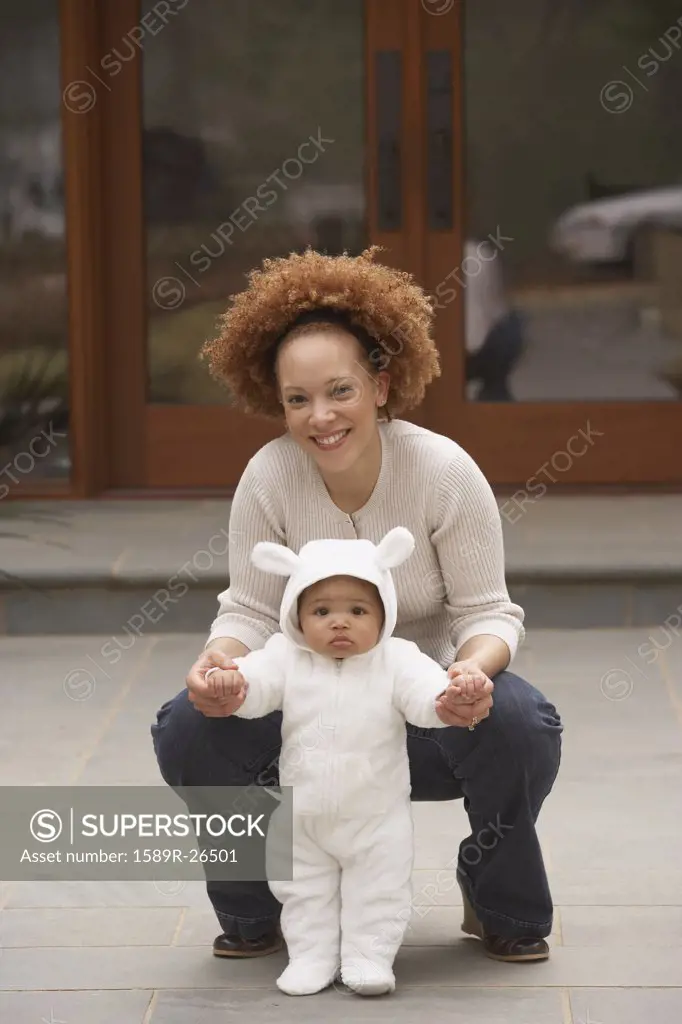 African mother with baby in bear costume