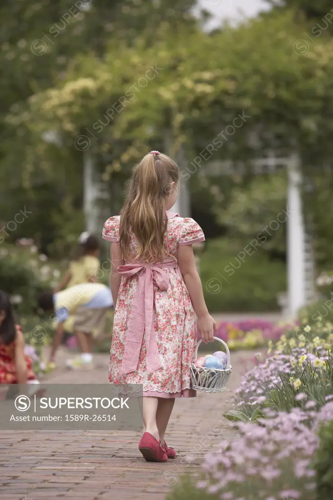Young girl with Easter basket in garden