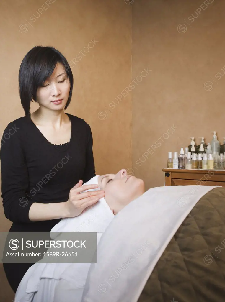 Woman receiving facial at spa
