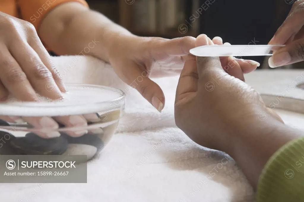 Close up of woman receiving manicure