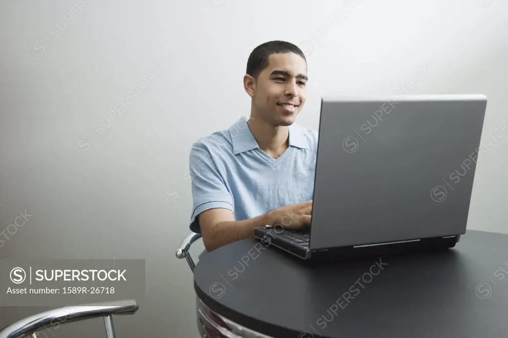Young African man using laptop