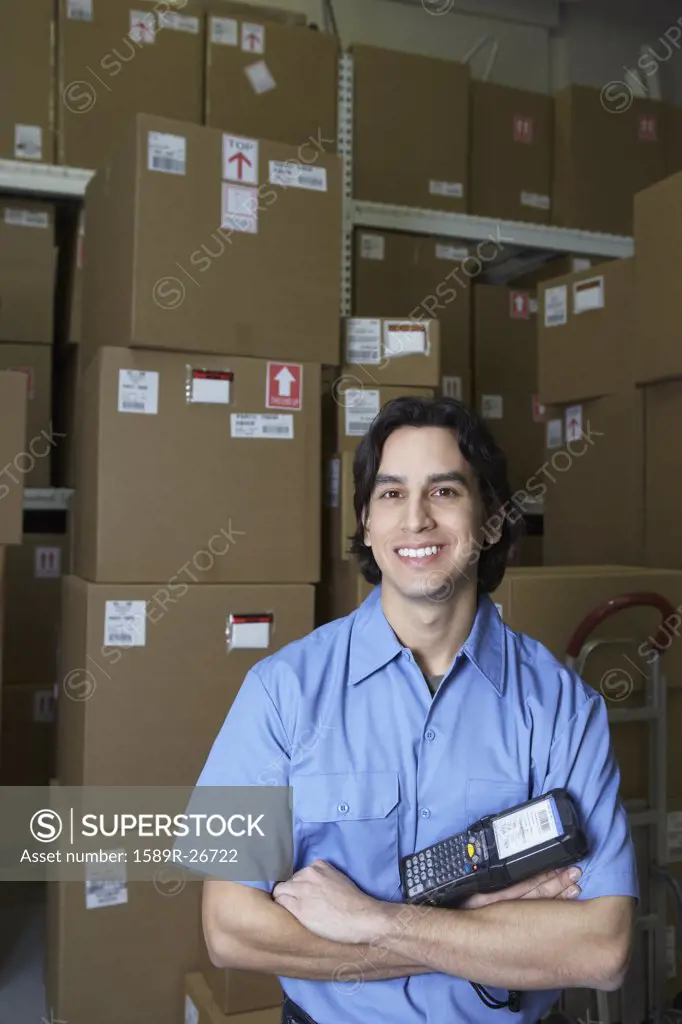 Hispanic male warehouse worker with barcode scanner