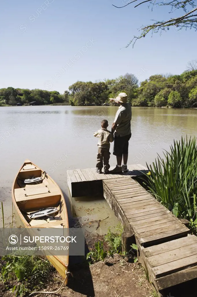 Father and son standing on dock